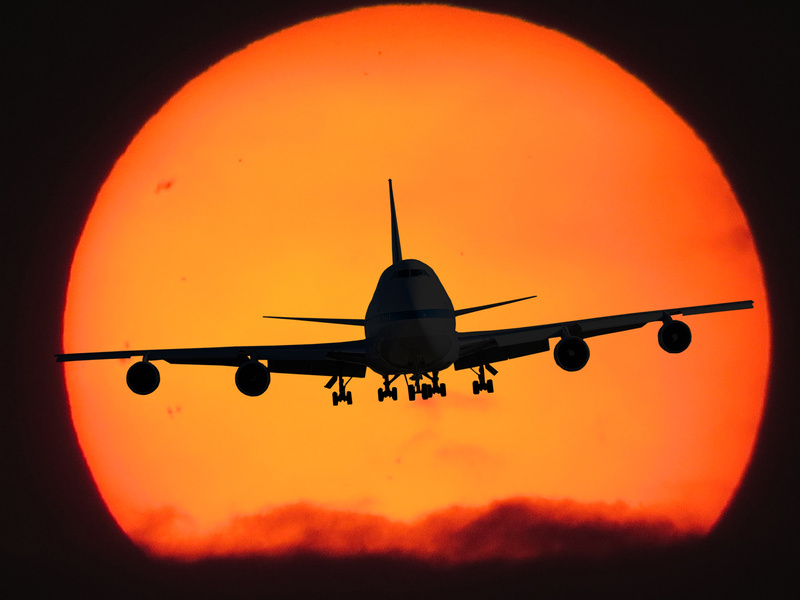 Airplane Silhouette on Sunset Background